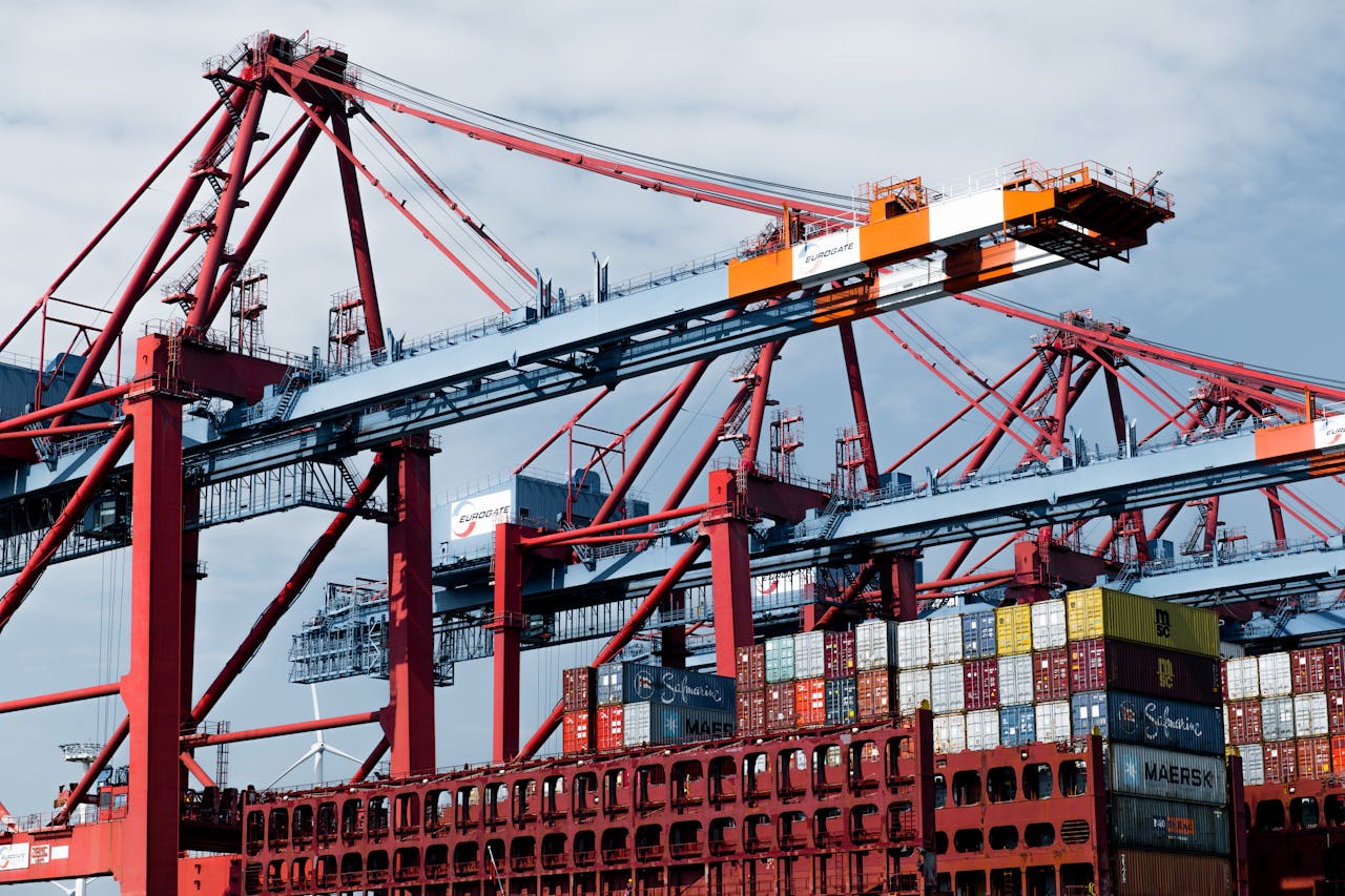 Cranes and shipping containers at Hamburg port, a hub of industry and trade.